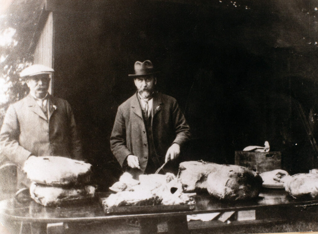 Photograph of Mr Staddon and Mr Fred Pook preparing meat